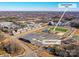 Aerial view of a modern townhome community, showcasing nearby parks, sports courts, and walking trails at 114 Marron Dr, Indian Trail, NC 28079