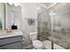 Bathroom featuring gray vanity, toilet, and tiled shower with glass doors, and a chrome towel bar at 114 Marron Dr, Indian Trail, NC 28079