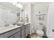 Bright bathroom featuring a double sink vanity, modern fixtures, and well-lit mirror at 114 Marron Dr, Indian Trail, NC 28079