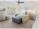 Sunlit bedroom features coordinated bedding, side tables, dresser, and neutral walls at 114 Marron Dr, Indian Trail, NC 28079