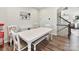 Bright dining room featuring an extended white table, bench, and chairs, adjacent to open staircase at 114 Marron Dr, Indian Trail, NC 28079