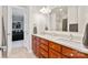 Bathroom with double sink vanity, granite countertops, framed mirror, and a view into the ensuite bedroom at 115 Union Chapel Dr, Mooresville, NC 28117