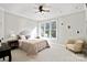 Bright bedroom featuring a large window, neutral tones, a ceiling fan, and minimal decorations at 115 Union Chapel Dr # 549, Mooresville, NC 28117