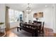 Dining room featuring a wooden table, bench seating, area rug, and bright lighting at 115 Union Chapel Dr, Mooresville, NC 28117