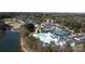 Stunning aerial view of community amenities featuring a pool, tennis courts, and golf course by the lake at 115 Union Chapel Dr, Mooresville, NC 28117