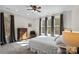 Bright bedroom with large windows, dark curtains, dresser, and chair, offering a relaxing and inviting space at 115 Union Chapel Dr, Mooresville, NC 28117
