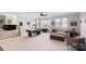 Expansive bonus room featuring an air hockey table, comfortable seating, and natural light from large windows at 115 Union Chapel Dr, Mooresville, NC 28117