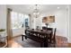 Bright dining room with large window, dark wood table and neutral decor at 115 Union Chapel Dr, Mooresville, NC 28117