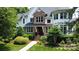 Charming brick and white two-story home with manicured lawn and mature landscaping at 115 Union Chapel Dr, Mooresville, NC 28117