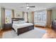 Serene main bedroom with hardwood floors, multiple windows, and neutral décor at 115 Union Chapel Dr, Mooresville, NC 28117