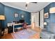 Home office with built in desk, hardwood floors, and accent chair at 115 Union Chapel Dr, Mooresville, NC 28117