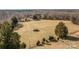 Aerial view of farm land with tractor and surrounding trees at 11745 Stokes Ferry Rd, Gold Hill, NC 28071