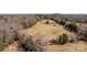 Aerial view showing farm land, barn, and surrounding forest at 11745 Stokes Ferry Rd, Gold Hill, NC 28071