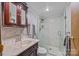 Bathroom with walk-in shower and dark wood vanity at 11745 Stokes Ferry Rd, Gold Hill, NC 28071