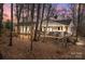 Ranch-style home on wooded lot with deck and American flag at 11745 Stokes Ferry Rd, Gold Hill, NC 28071