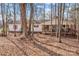 House nestled in the woods with a porch and American flag at 11745 Stokes Ferry Rd, Gold Hill, NC 28071