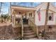 Home with a covered porch and brick steps leading to the entrance at 11745 Stokes Ferry Rd, Gold Hill, NC 28071