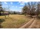 Open field with a rustic cabin and a long driveway at 11745 Stokes Ferry Rd, Gold Hill, NC 28071