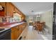 Rustic kitchen with wood cabinets and a dining area at 11745 Stokes Ferry Rd, Gold Hill, NC 28071