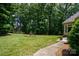 Spacious backyard with lush lawn, stone birdbath, and walkway at 119 Barton Pl, Mooresville, NC 28117