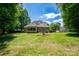 Large backyard with a sunroom and a view of the surrounding trees at 119 Barton Pl, Mooresville, NC 28117