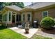 Brick home with sunroom and patio, surrounded by lush landscaping at 119 Barton Pl, Mooresville, NC 28117