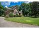 Brick home with a curved driveway and lush green lawn at 119 Barton Pl, Mooresville, NC 28117