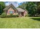 Brick home with manicured lawn and landscaping at 119 Barton Pl, Mooresville, NC 28117