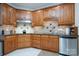 Kitchen features dark wood cabinets, granite countertops, and stainless steel appliances at 119 Barton Pl, Mooresville, NC 28117