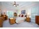 Large main bedroom with tray ceilings, ample natural light, and wood furniture at 119 Barton Pl, Mooresville, NC 28117