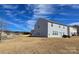 Backyard with a neutral-colored house, windows, a sliding glass door, and view of a neighborhood at 121 Mackinac Dr, Mooresville, NC 28117