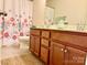 Bright bathroom featuring a double vanity with wood cabinets, neutral walls, and chrome fixtures at 121 Mackinac Dr, Mooresville, NC 28117