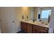 Bright bathroom featuring double sinks, a large mirror, and a window providing natural light at 121 Mackinac Dr, Mooresville, NC 28117