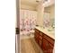 Bright bathroom featuring a double vanity, neutral walls, and a shower with a patterned curtain at 121 Mackinac Dr, Mooresville, NC 28117