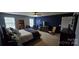 Comfortable bedroom with plush carpet, neutral walls, and abundant natural light from the bright windows at 121 Mackinac Dr, Mooresville, NC 28117