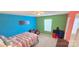 Brightly painted bedroom features a bed, storage unit, and natural light from a window at 121 Mackinac Dr, Mooresville, NC 28117