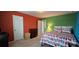 Colorful bedroom with a bed, dresser, and doorway leading to an adjacent room at 121 Mackinac Dr, Mooresville, NC 28117