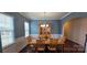 Charming dining room with wainscoting, a wooden table set, and natural light from the window at 121 Mackinac Dr, Mooresville, NC 28117