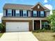 Charming two-story home featuring a two-car garage, brick accents, and a well-maintained lawn at 121 Mackinac Dr, Mooresville, NC 28117