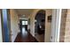 Inviting foyer with hardwood floors, arched doorways, and view into the living area at 121 Mackinac Dr, Mooresville, NC 28117