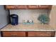 Kitchen counter featuring granite countertops, wood cabinetry, tile backsplash, and a coffee maker at 121 Mackinac Dr, Mooresville, NC 28117