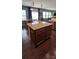 Close-up of a kitchen island featuring granite countertops, wood cabinetry, and a view of the dining area at 121 Mackinac Dr, Mooresville, NC 28117