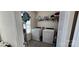A functional laundry room equipped with washer, dryer, shelving, and storage solutions at 121 Mackinac Dr, Mooresville, NC 28117