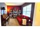Eclectic living room featuring a red sofa, bookshelves, piano, and inviting decor at 121 Mackinac Dr, Mooresville, NC 28117