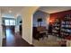 Inviting living room features hardwood floors, piano and elegant archway into connecting spaces at 121 Mackinac Dr, Mooresville, NC 28117