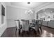 Modern dining room with dark hardwood floors and a stylish light fixture at 12904 Vermillion Xing, Huntersville, NC 28078