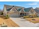 Brick front house with 2-car garage and landscaping at 12904 Vermillion Xing, Huntersville, NC 28078