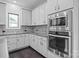 Modern kitchen features stainless steel appliances and gray cabinetry at 12904 Vermillion Xing, Huntersville, NC 28078