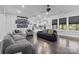 Open living room with hardwood floors, modern sofas, and views into the kitchen area at 12904 Vermillion Xing, Huntersville, NC 28078