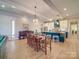 Open dining area with hardwood floors, farmhouse table, and kitchen views at 168 Tanglewood Cv, Belmont, NC 28012